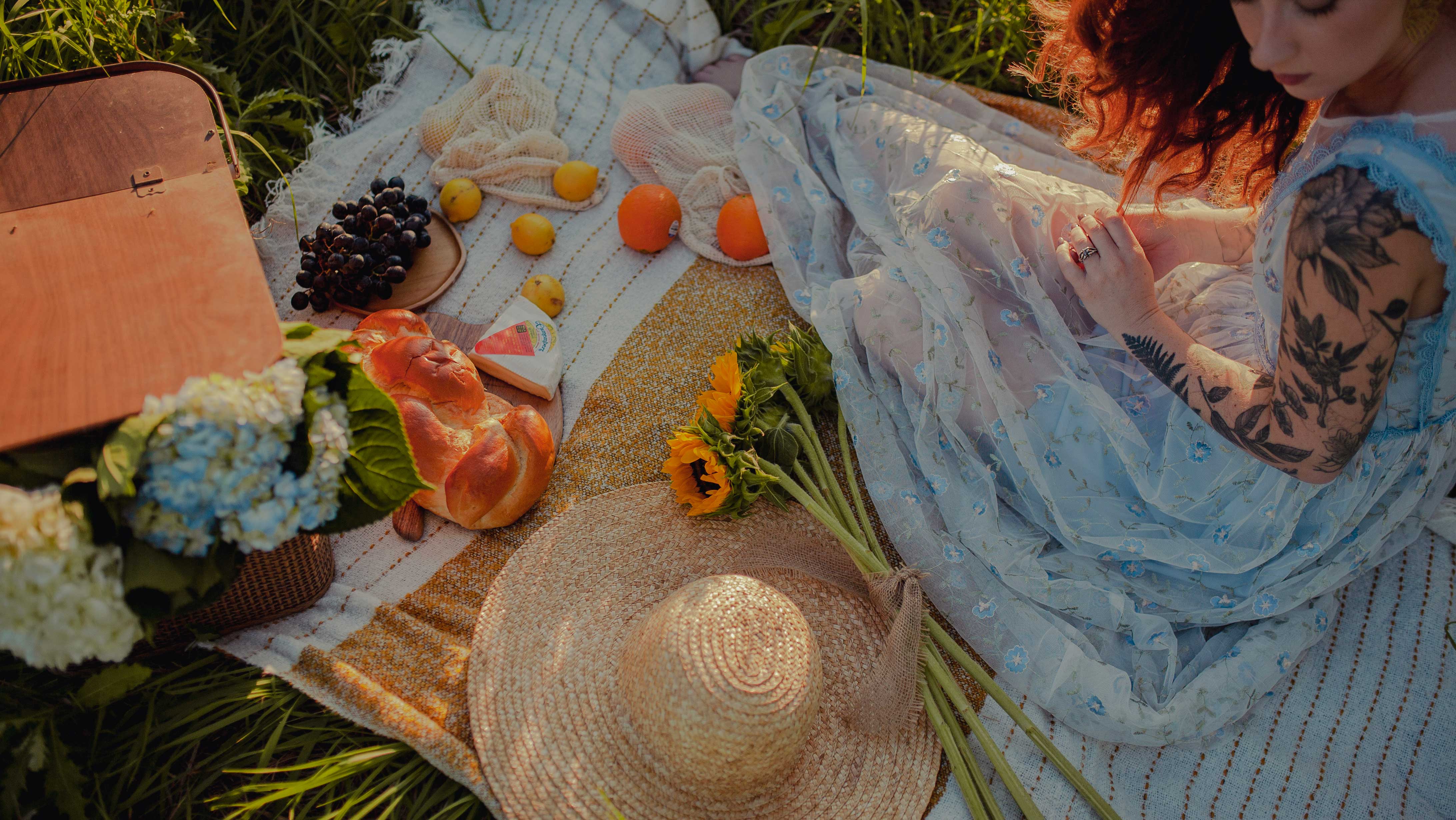 A beautiful overhead look at a lady having a picnic outdoors in the sun